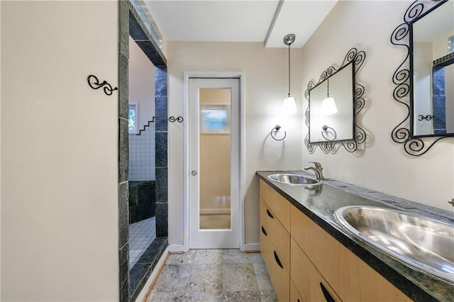 bathroom with vanity and tiled shower