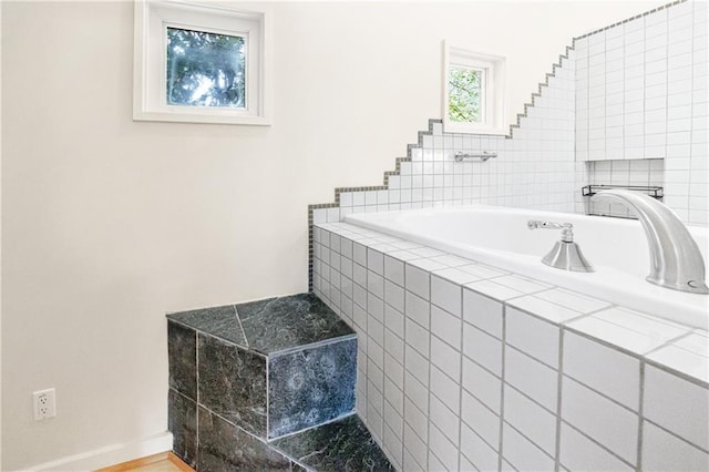 bathroom with tiled bath