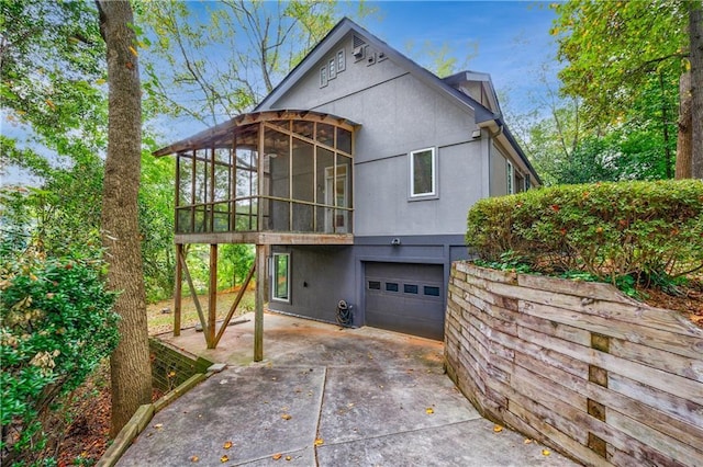 exterior space with a sunroom and a garage