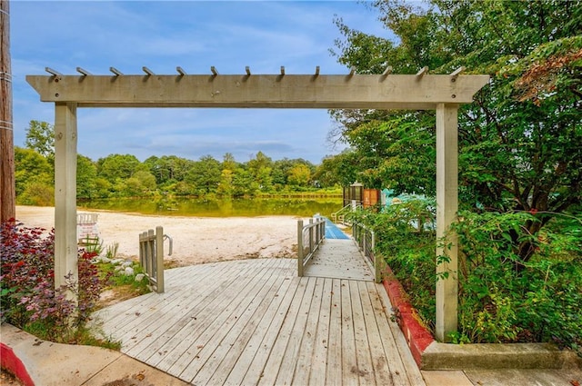 surrounding community featuring a deck with water view