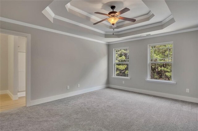 506 Tallapoosa Trl, Woodstock, GA 30188 - unfurnished room featuring ornamental molding, ceiling fan, carpet floors, a tray ceiling, and baseboards