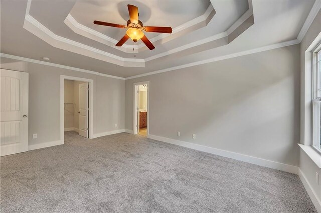506 Tallapoosa Trl, Woodstock, GA 30188 - unfurnished bedroom with a ceiling fan, carpet, crown molding, a walk in closet, and a raised ceiling
