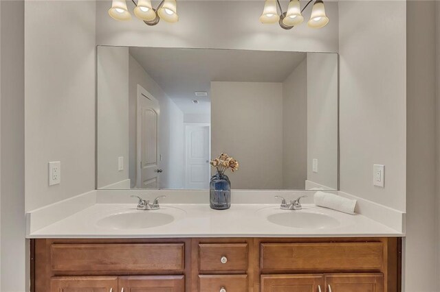 506 Tallapoosa Trl, Woodstock, GA 30188 - bathroom featuring a sink, double vanity, and a notable chandelier