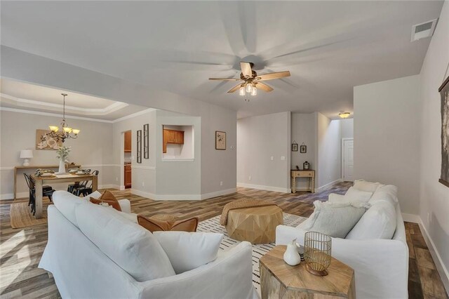 506 Tallapoosa Trl, Woodstock, GA 30188 - living room with a tray ceiling, light wood-style flooring, baseboards, visible vents, and ceiling fan with notable chandelier