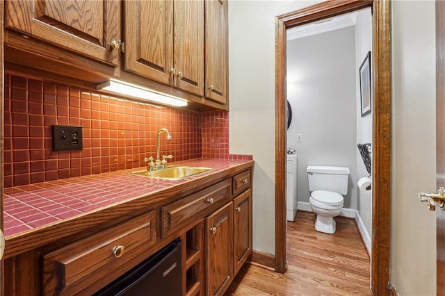 bathroom with vanity, hardwood / wood-style floors, toilet, and tasteful backsplash