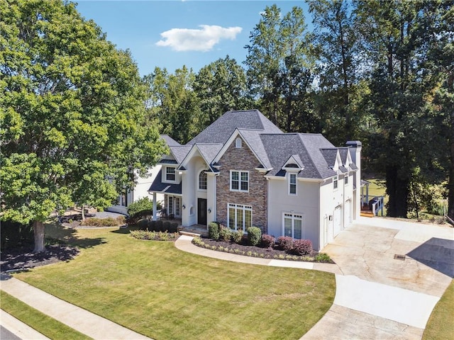 view of front of property with a front lawn and a garage