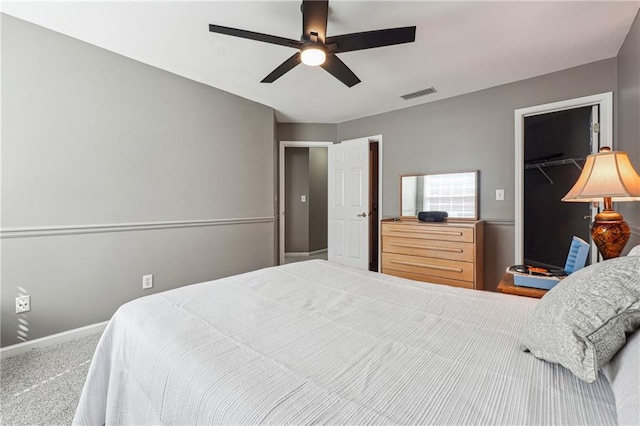 bedroom with ceiling fan, carpet floors, a closet, and a spacious closet