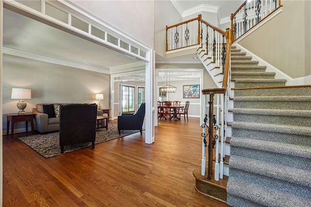 foyer entrance featuring crown molding and hardwood / wood-style floors