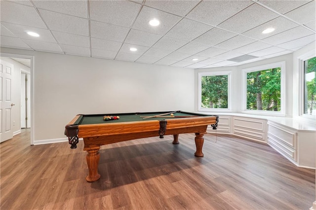 recreation room featuring billiards, light wood-type flooring, and a paneled ceiling