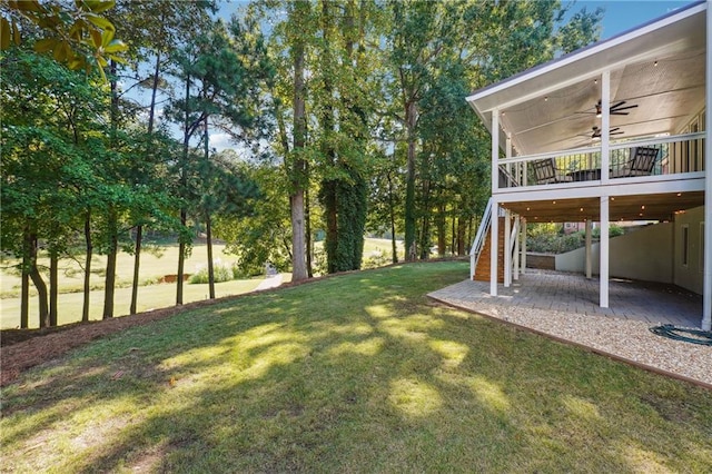 view of yard with a patio and ceiling fan