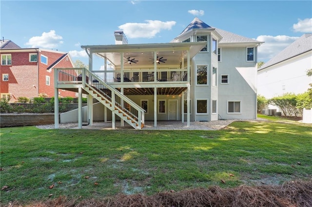 rear view of property featuring a patio, a deck, a yard, and ceiling fan