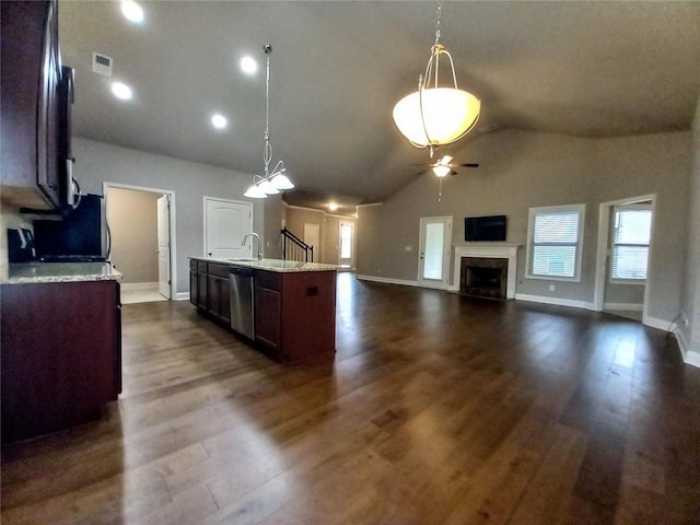 kitchen with stainless steel dishwasher, dark wood-type flooring, visible vents, and a high end fireplace