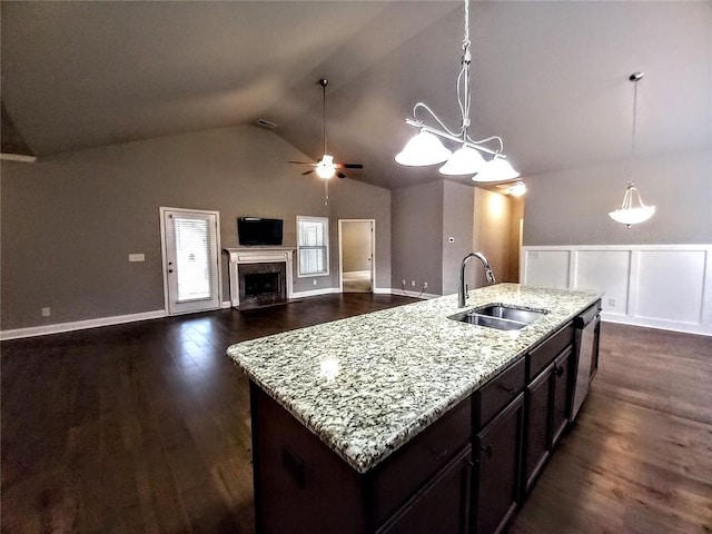 kitchen featuring pendant lighting, a sink, dark wood-style floors, a high end fireplace, and dishwasher