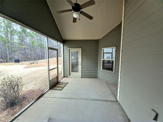 sunroom featuring a ceiling fan and vaulted ceiling