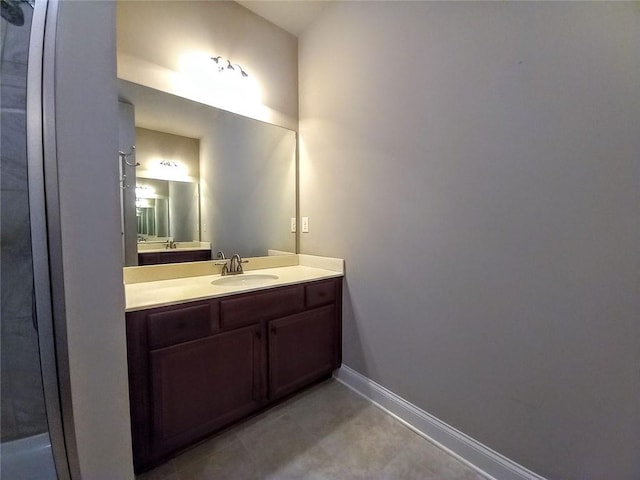 bathroom featuring tile patterned floors, baseboards, and vanity