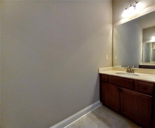 bathroom featuring baseboards and vanity