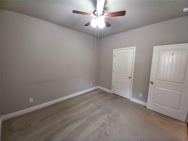 unfurnished bedroom featuring carpet flooring, ceiling fan, and baseboards