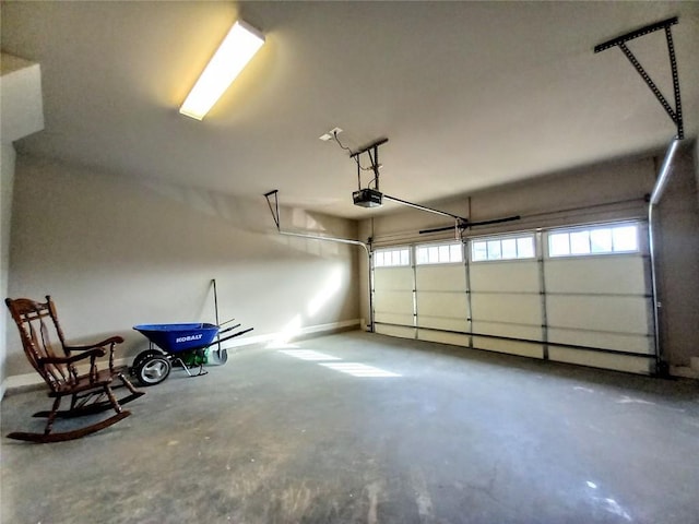 garage featuring a garage door opener and baseboards