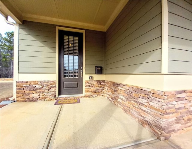 view of exterior entry with stone siding