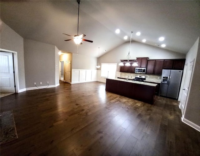 kitchen featuring dark wood-style floors, open floor plan, appliances with stainless steel finishes, and light countertops