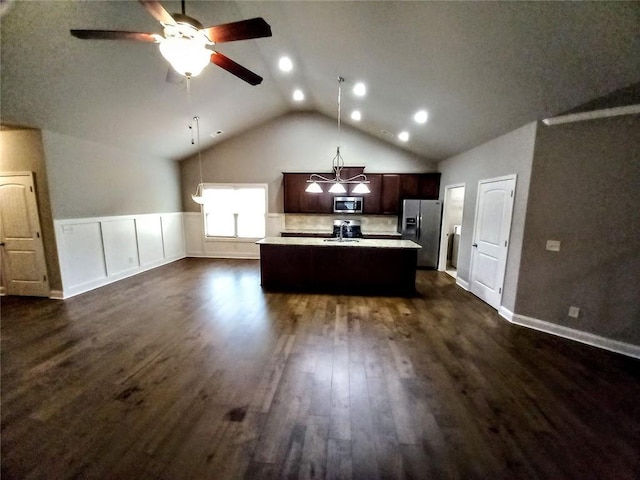 kitchen with dark wood-type flooring, a sink, dark brown cabinetry, appliances with stainless steel finishes, and light countertops