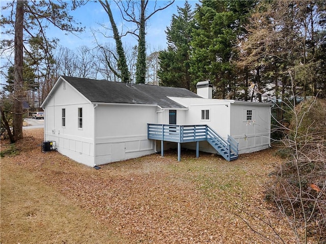 back of house featuring a wooden deck and central AC unit