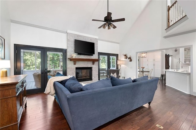 1642 Reflections Trl, Powder Springs, GA 30127 - living area featuring french doors, a ceiling fan, plenty of natural light, a fireplace, and high vaulted ceiling
