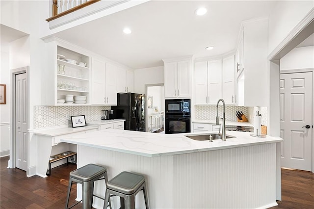 1642 Reflections Trl, Powder Springs, GA 30127 - kitchen featuring black appliances, dark wood-style floors, white cabinets, decorative backsplash, and recessed lighting