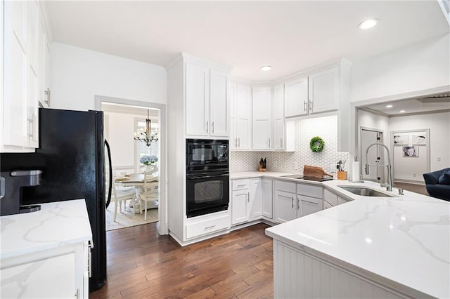 1642 Reflections Trl, Powder Springs, GA 30127 - kitchen with black appliances, dark wood-style flooring, white cabinetry, and recessed lighting