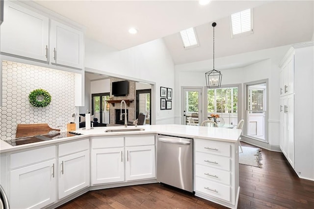 1642 Reflections Trl, Powder Springs, GA 30127 - kitchen with dishwasher, black electric stovetop, a peninsula, light countertops, and white cabinets