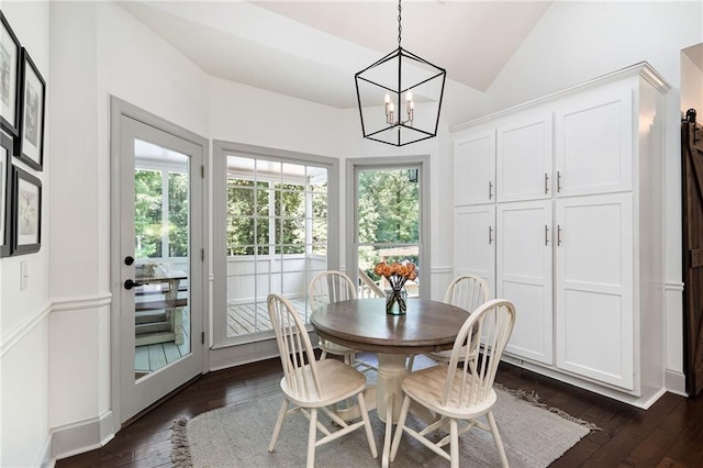 1642 Reflections Trl, Powder Springs, GA 30127 - dining area with dark wood finished floors, vaulted ceiling, and a chandelier