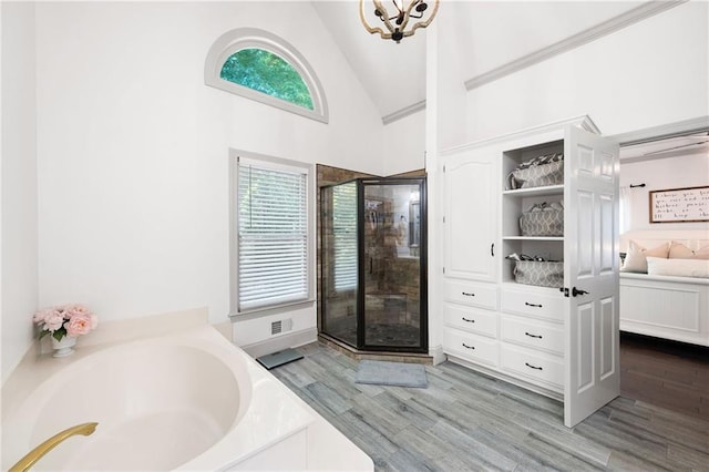 1642 Reflections Trl, Powder Springs, GA 30127 - full bath featuring a garden tub, a shower stall, wood finished floors, high vaulted ceiling, and connected bathroom
