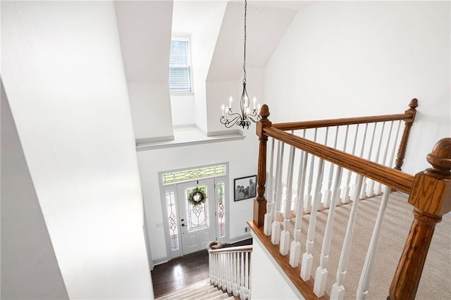 1642 Reflections Trl, Powder Springs, GA 30127 - stairway with healthy amount of natural light, a chandelier, wood finished floors, and high vaulted ceiling