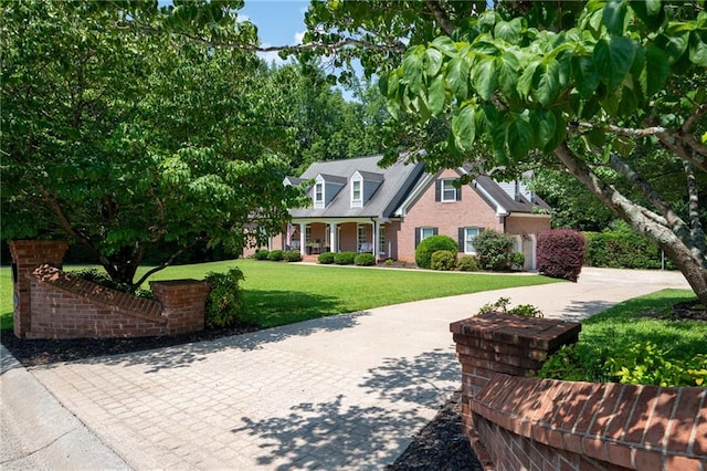 1642 Reflections Trl, Powder Springs, GA 30127 - cape cod home with a front lawn, a porch, and brick siding
