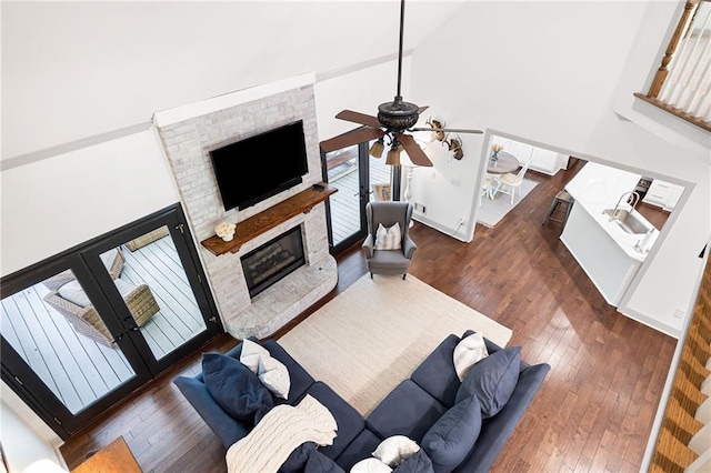 1642 Reflections Trl, Powder Springs, GA 30127 - living room with a ceiling fan, french doors, a fireplace, wood-type flooring, and high vaulted ceiling