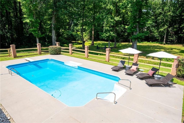 1642 Reflections Trl, Powder Springs, GA 30127 - view of swimming pool with a patio area, a diving board, and view of wooded area