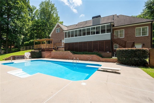 1642 Reflections Trl, Powder Springs, GA 30127 - swimming pool featuring stairs, a sunroom, a diving board, and a patio area