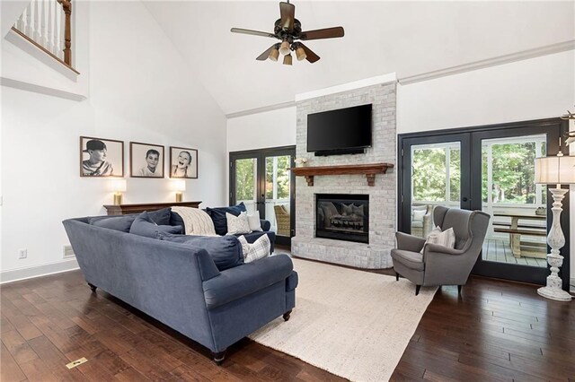 1642 Reflections Trl, Powder Springs, GA 30127 - living room featuring high vaulted ceiling, french doors, dark wood finished floors, ceiling fan, and a fireplace