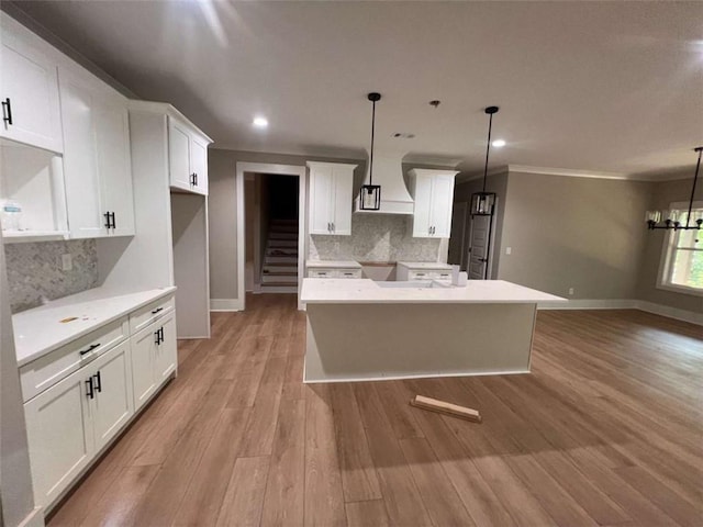 381 Chattahoochee Glen Rd, Clarkesville, GA 30523 - kitchen with decorative backsplash, baseboards, a kitchen island, recessed lighting, and ornamental molding