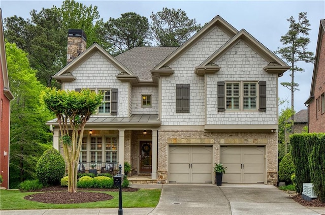 craftsman-style home featuring brick siding, a garage, a porch, a chimney, and concrete driveway