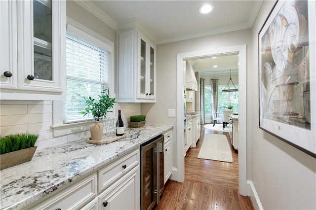 bar with backsplash, recessed lighting, wine cooler, and wood finished floors