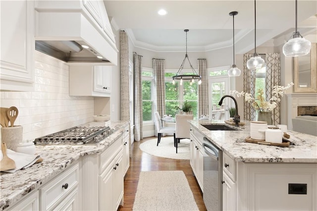 kitchen with white cabinets, a sink, stainless steel appliances, dark wood-type flooring, and custom exhaust hood