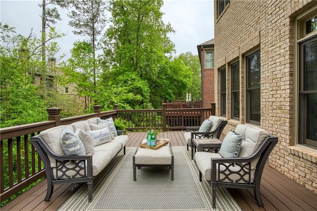 wooden terrace with an outdoor hangout area
