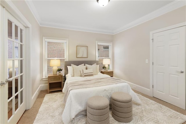 bedroom featuring light colored carpet, ornamental molding, and baseboards