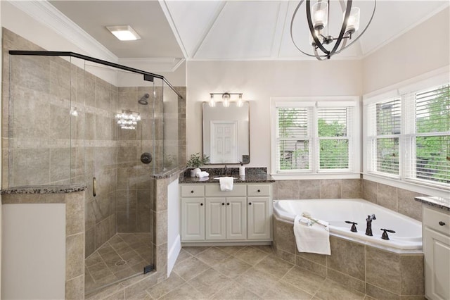 bathroom featuring a garden tub, a shower stall, vanity, a chandelier, and ornamental molding