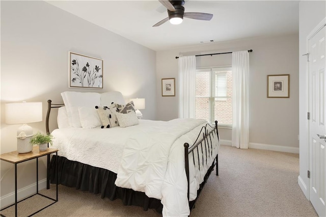 carpeted bedroom featuring baseboards, ceiling fan, and visible vents