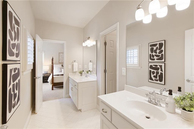ensuite bathroom featuring two vanities, a sink, tile patterned floors, an inviting chandelier, and ensuite bath