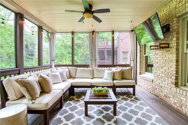 sunroom / solarium featuring an outdoor living space, ceiling fan, and a wealth of natural light