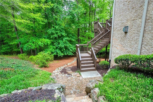 view of yard featuring a deck and stairs