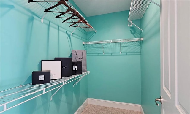 spacious closet with carpet flooring
